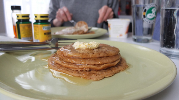 pancakes at diner drowning in syrup with butter on top